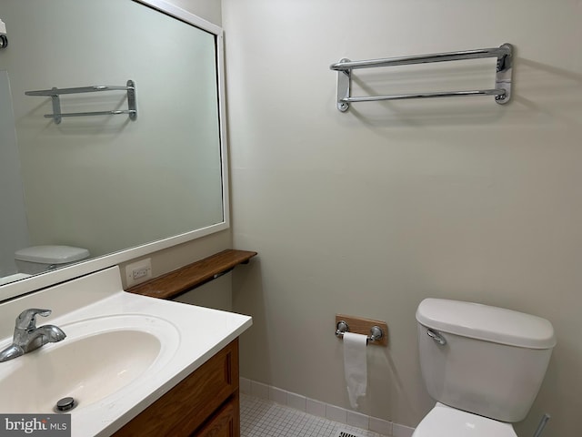 bathroom featuring toilet, vanity, and tile patterned floors