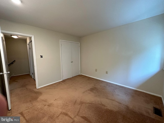 unfurnished bedroom with light colored carpet