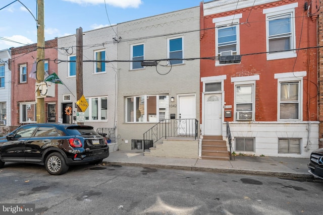 multi unit property featuring brick siding and a residential view