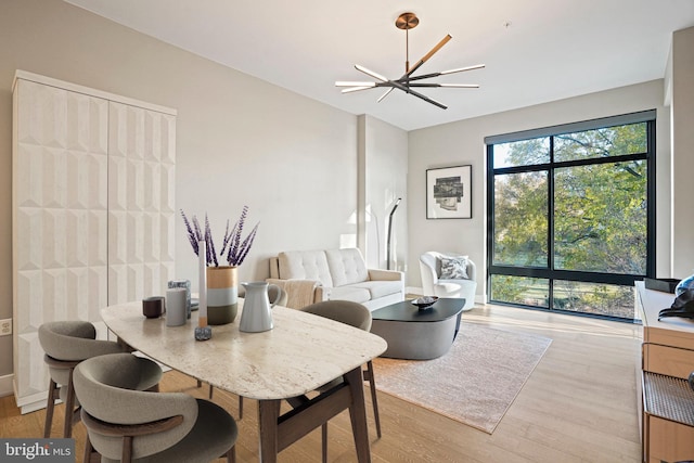 dining room featuring light hardwood / wood-style floors and an inviting chandelier