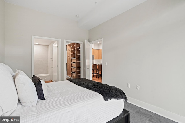 bedroom featuring a walk in closet and a closet