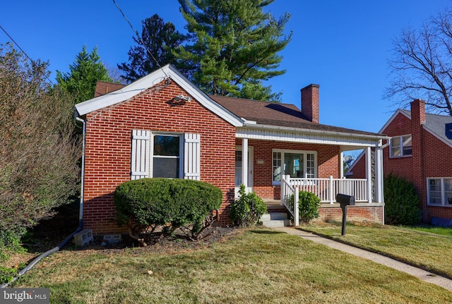 bungalow featuring a porch and a front lawn