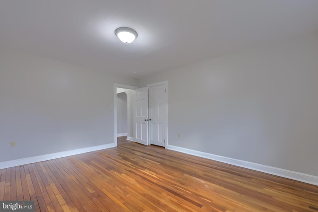 spare room featuring wood-type flooring