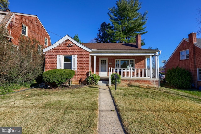 bungalow-style home with a porch and a front lawn