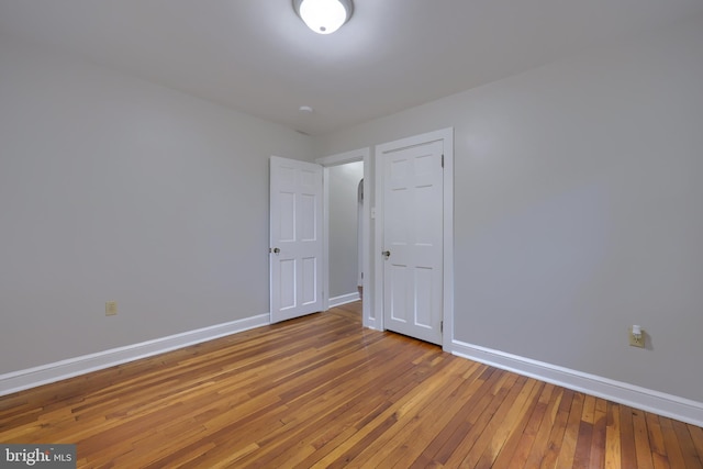 spare room with hardwood / wood-style floors