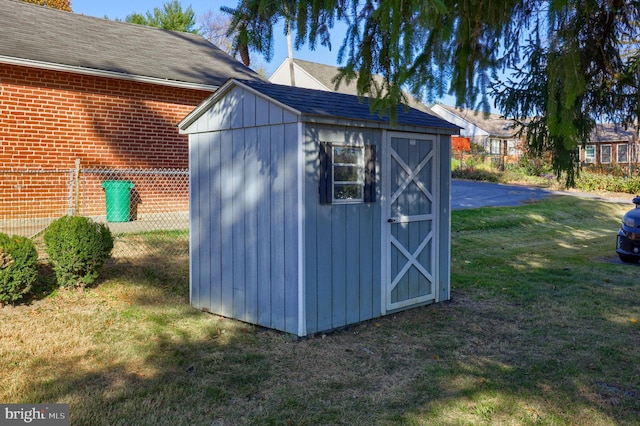 view of outbuilding featuring a lawn