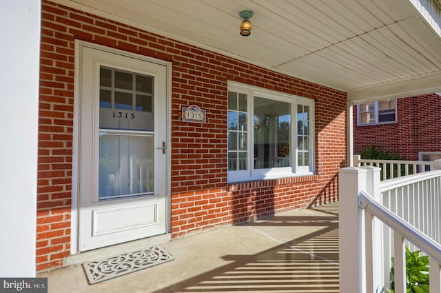 doorway to property featuring covered porch