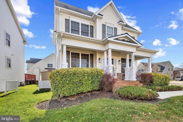 view of front of home featuring a front lawn and covered porch