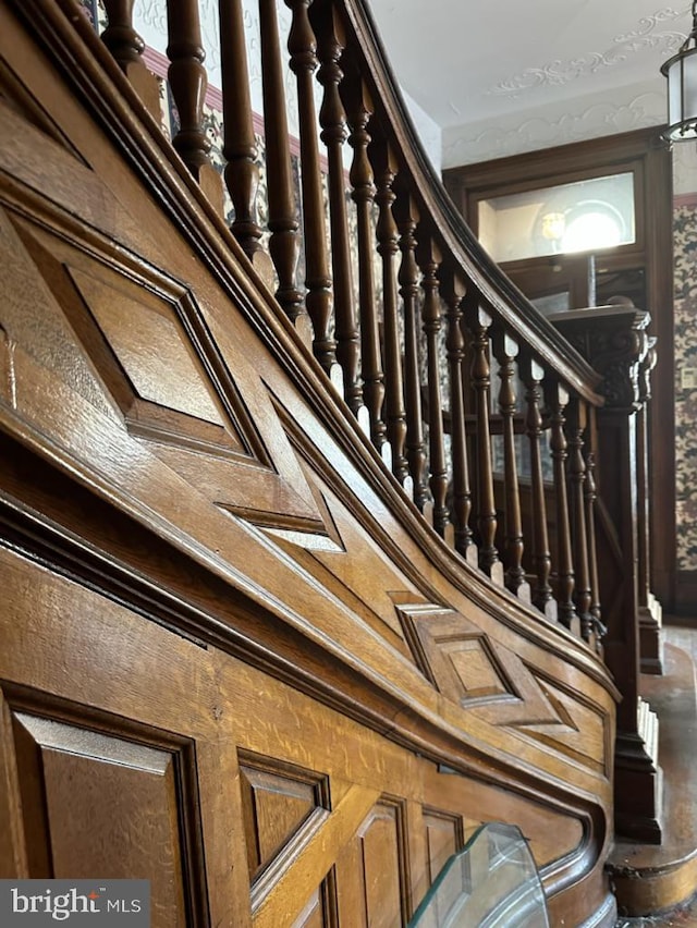 stairs featuring wood walls