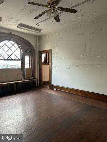 spare room with ceiling fan and wood-type flooring