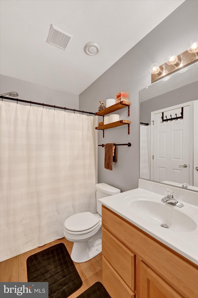 bathroom featuring hardwood / wood-style floors, vanity, and toilet