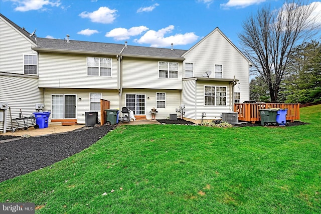 back of house featuring a yard, a patio, and central AC