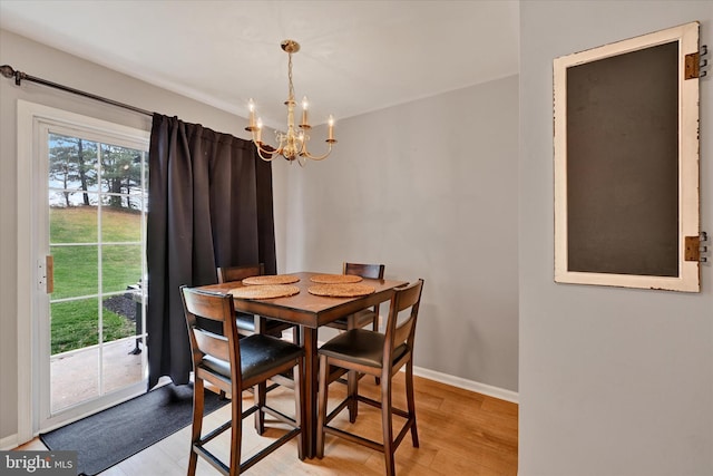 dining area with a chandelier and light hardwood / wood-style floors