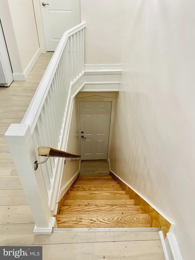 stairs with wood-type flooring