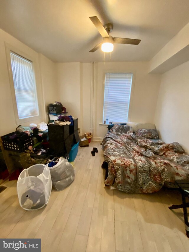 bedroom featuring light wood-type flooring and ceiling fan