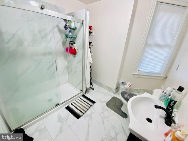 bathroom featuring sink and a shower with shower door