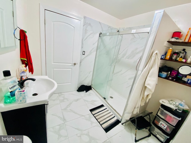 bathroom featuring vanity and a shower with door