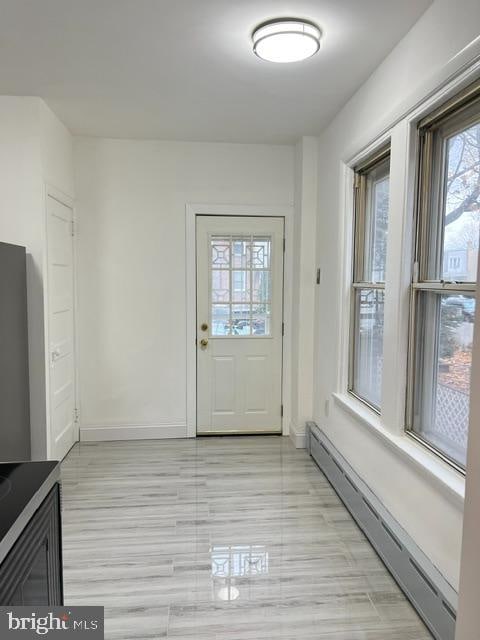 doorway to outside with a baseboard radiator