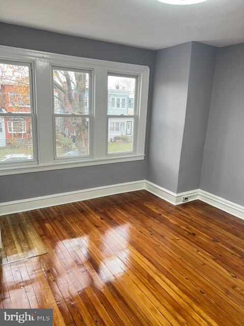 unfurnished room with wood-type flooring