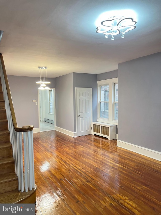 interior space featuring hardwood / wood-style flooring, radiator, and a baseboard radiator