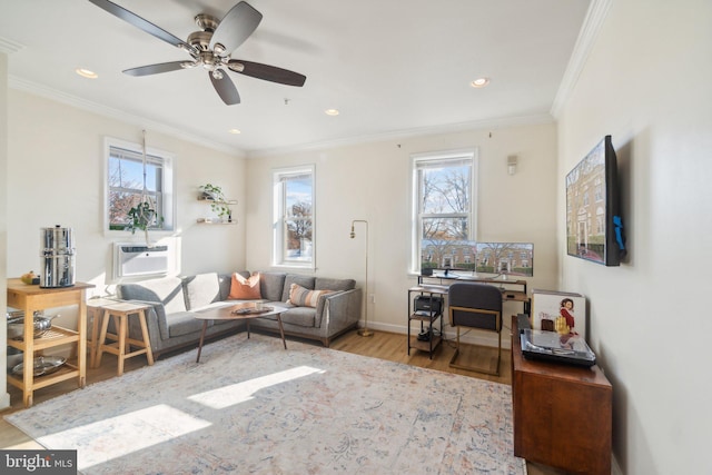 living room featuring a healthy amount of sunlight, crown molding, ceiling fan, and light hardwood / wood-style floors