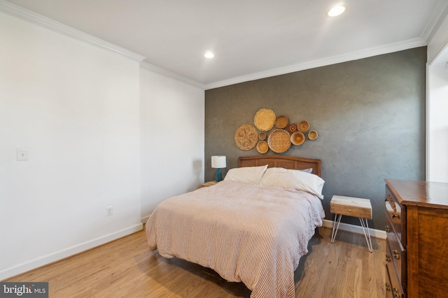 bedroom featuring crown molding and light wood-type flooring