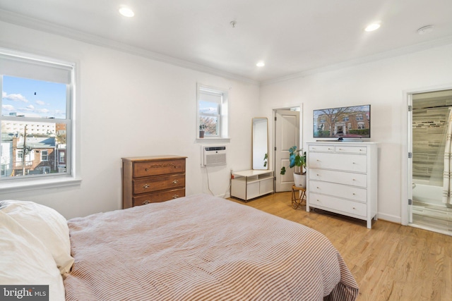 bedroom with connected bathroom, multiple windows, ornamental molding, and light wood-type flooring