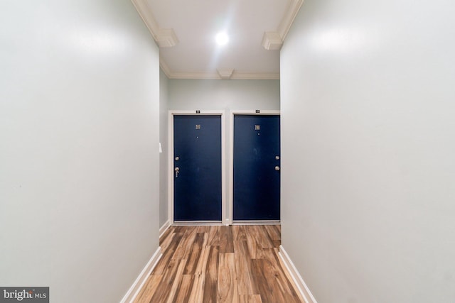 hall with hardwood / wood-style flooring and ornamental molding