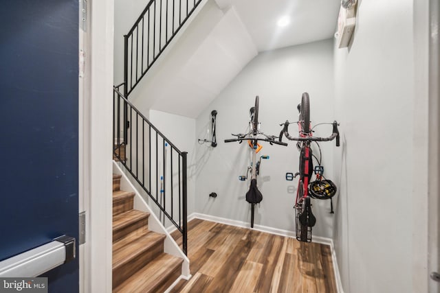 entryway featuring wood-type flooring and vaulted ceiling