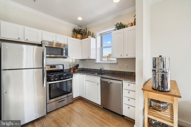 kitchen featuring white cabinets, light hardwood / wood-style floors, and appliances with stainless steel finishes