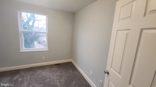 carpeted spare room with baseboards