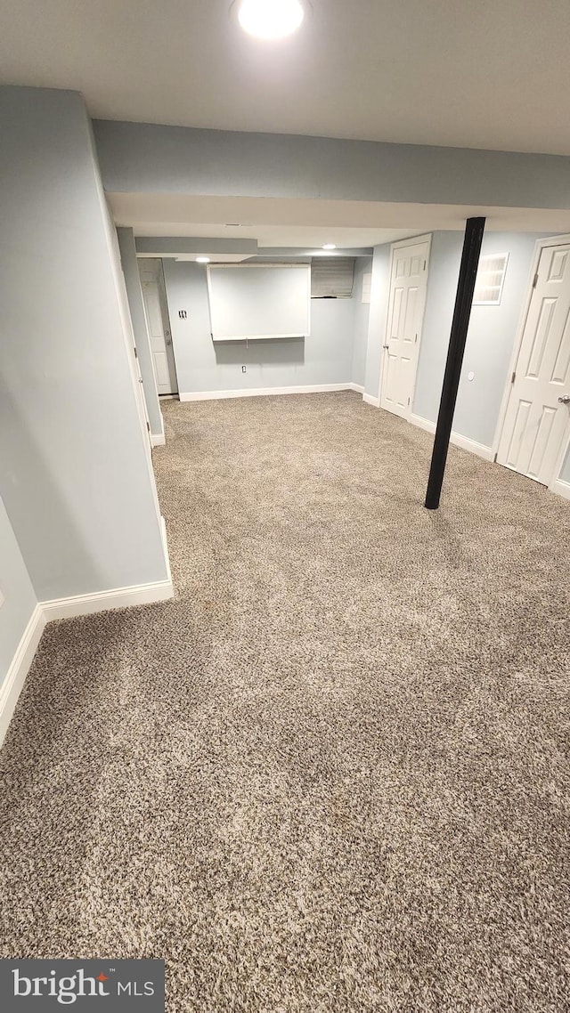 finished basement with baseboards and carpet flooring