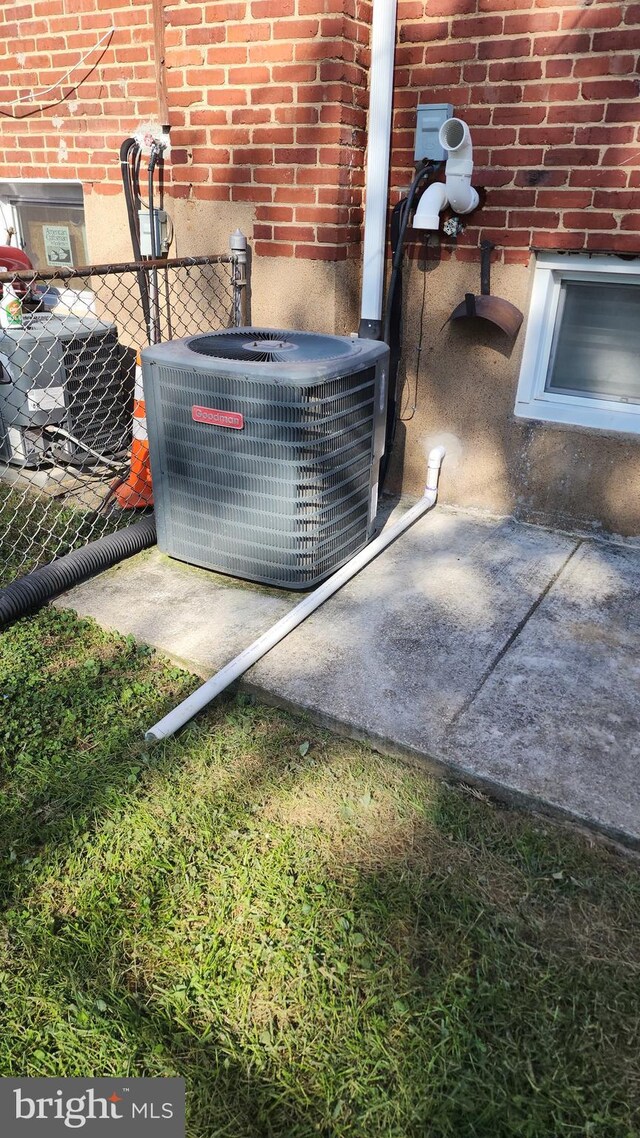 exterior details with central AC and brick siding