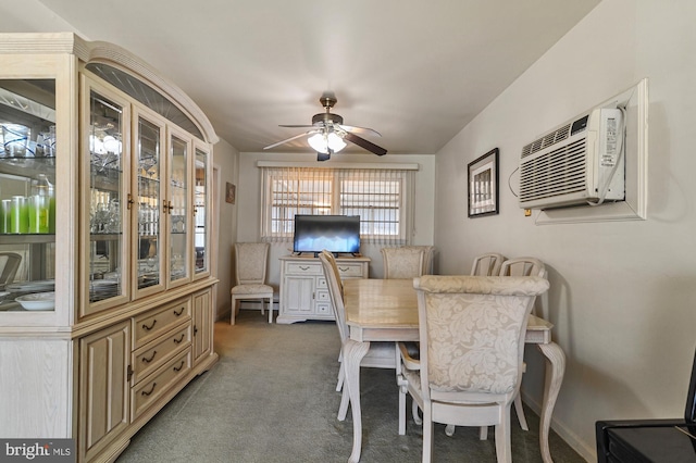 carpeted dining space with a wall unit AC and ceiling fan