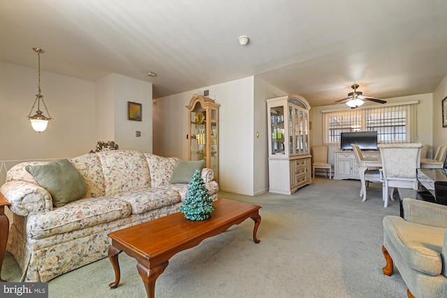 carpeted living room featuring ceiling fan