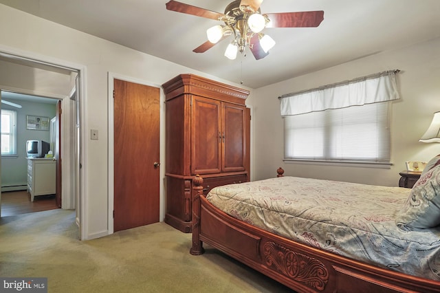 carpeted bedroom featuring ceiling fan and a baseboard radiator