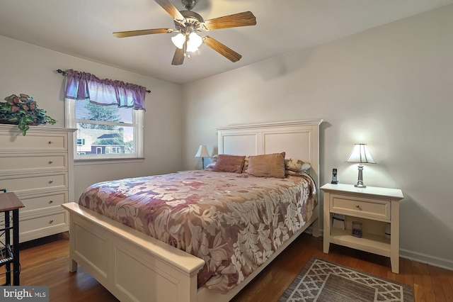 bedroom with ceiling fan and dark hardwood / wood-style floors