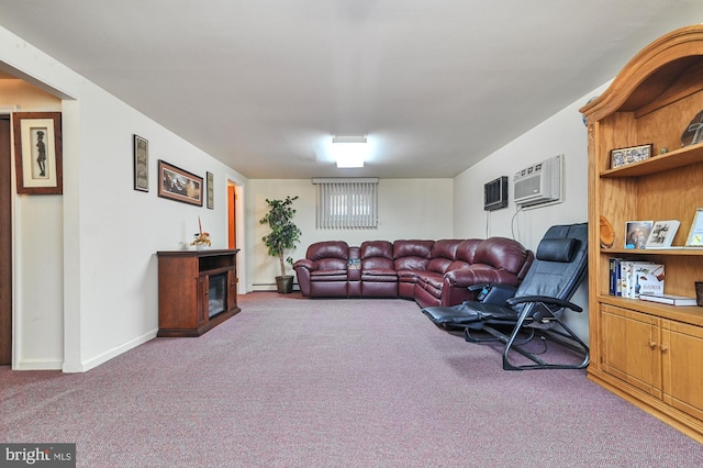 living room featuring baseboard heating, a wall mounted AC, and carpet floors