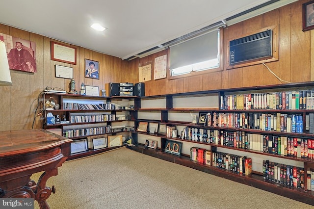 interior space featuring carpet, an AC wall unit, and wooden walls