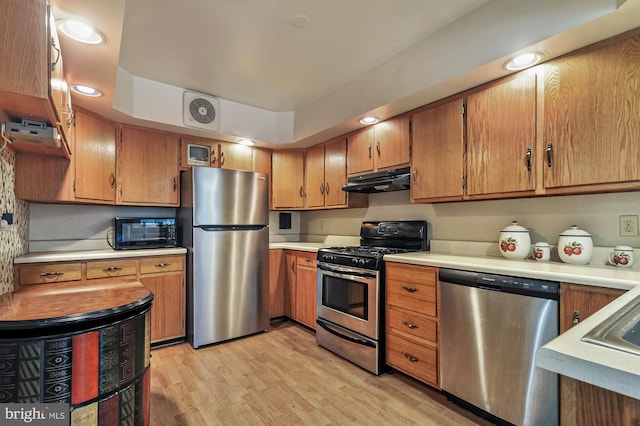 kitchen featuring stainless steel appliances and light hardwood / wood-style floors