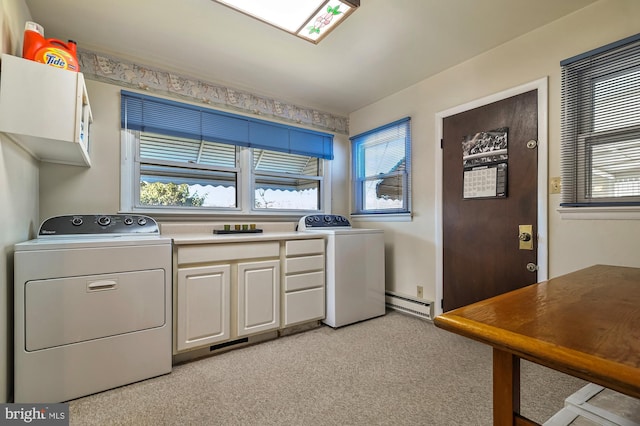 laundry room featuring a wealth of natural light, cabinets, a baseboard radiator, and light carpet