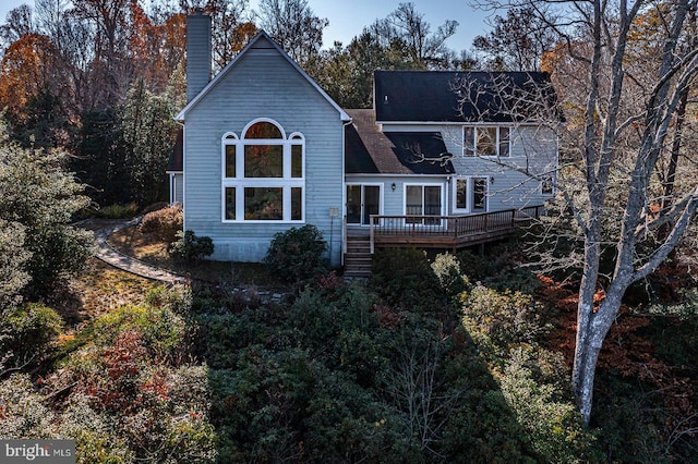 rear view of house featuring a deck