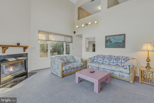 living room featuring a high ceiling and carpet floors