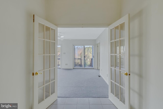 corridor with french doors and light colored carpet