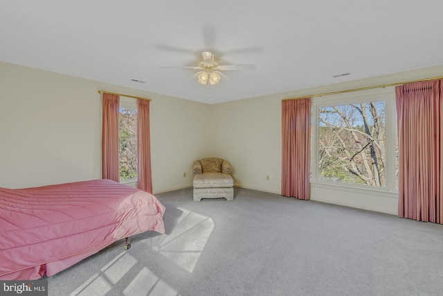 bedroom with ceiling fan and light colored carpet