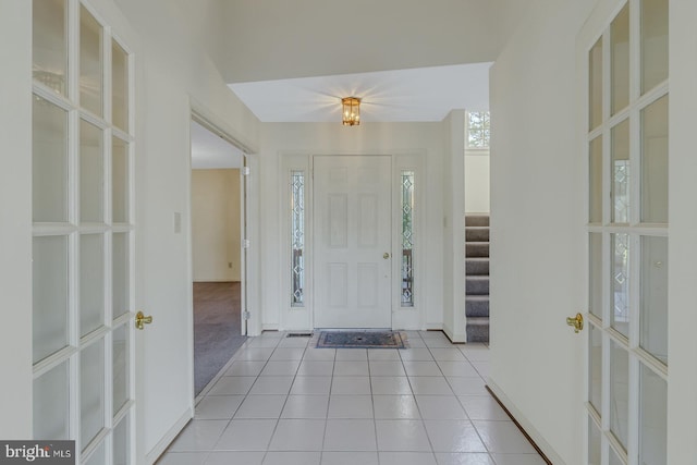 foyer entrance with light colored carpet