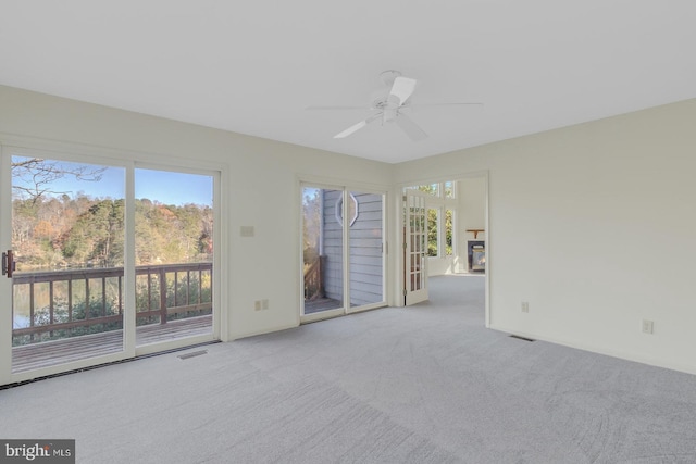 carpeted empty room featuring ceiling fan