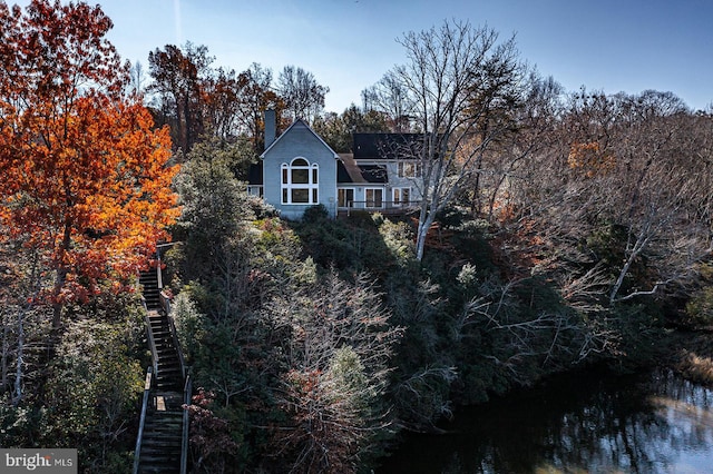 rear view of house featuring a water view