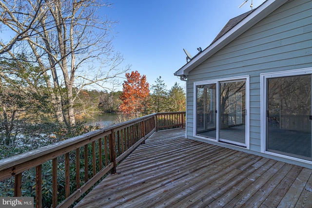 wooden terrace featuring a water view