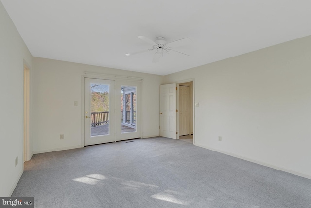 carpeted spare room with ceiling fan